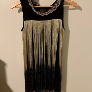 Tank top with gold and shiny black frange. Metal golden collar.